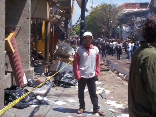 A man standing amongst the wreckage at the site of the bombing, Kuta, Bali, 12 October 2002 [picture] / Gede Bingin