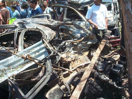 Wreckage of a car at the site of the bombing, Kuta, Bali, 12 October 2002 [3] [picture] / Gede Bingin