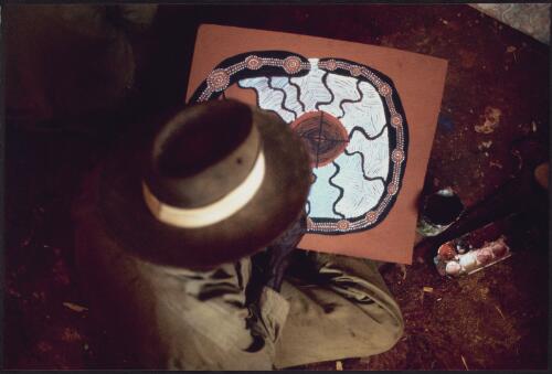 [Old Walter Tjampitjinpa working on Rainbow and water story in the Men's Painting Room, Papunya,  1972] [picture] / Michael Jensen
