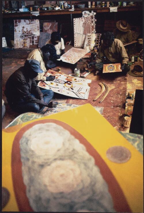 [Indigenous artists Charlie Tarawa (Tjaruru) Tjungurrayi, Johnny Warangkula Tjupurrula, Timmy Payungka Tjapangati and Kaapa Mbitjana Tjampitjinpa working at the artist's studio, Papunya, 1972] [picture] / Michael Jensen