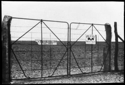 Border Fence with a sign to Tibooburra, 35 m. at the border of Queensland and New South Wales, near the exploration routes of Burke & Wills and Sturt, 1935 [picture]
