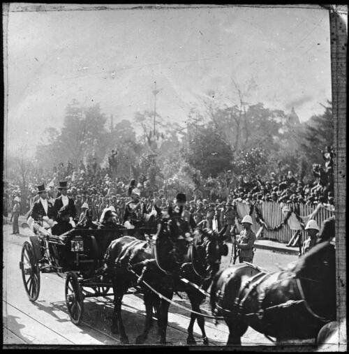 The Duke & Duchess of Cornwall and York in an open carriage proceeding  to lay the foundation stone for the Soldiers' Monuments, Melbourne, May 1901 [transparency]