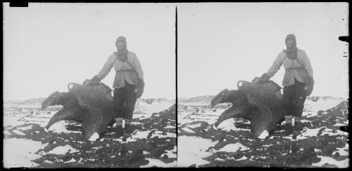 Griffith Taylor standing next to a weathered kenyte southeast of Hut Point near Cape Evans, Antarctica, 15 October 1911 [picture]