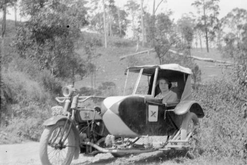Excelsior motor-cycle with side-car combination, and lady passenger, owned by photographer [picture] / W. E. Sharpe
