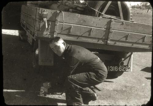 [Reverend Les McKay, of the Australian Inland Mission Western Queensland patrol, working on a truck, ca. 1950s] [picture]