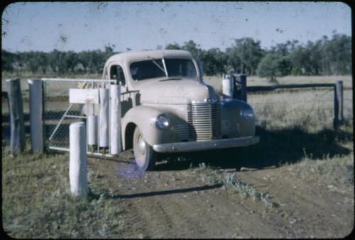 Reverend Les McKay's vehicle at gate at Lorne Peak station, Queensland, ca. 1950s [transparency] / Les McKay