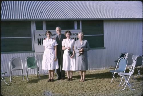 Sir Henry Abel Smith, Governor of Queensland, Lady May Abel Smith and two AIM nurses outside the AIM hospital, Birdsville, Queensland, 1964 [transparency] / Les McKay