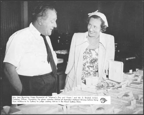 Mrs. Jean Bowering, home economist of 'Woman's Day and Home', and Mr. S. Birchall, A.N.A. catering officer, inspecting the plane catering kitchen of Australian National Airways before flying from Melbourne to Sydney to judge cooking entries in the Royal Sydney Show [picture]