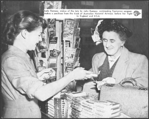 Lady Ramsay, widow of the late Sir John Ramsay, outstanding Tasmanian surgeon, makes a purchase from the kiosk of Australian National Airways, before her flight to England and U.S.A. [picture]