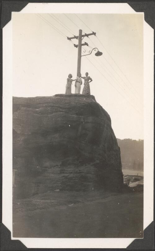 [Dancers from the Monte Carlo Russian Ballet standing on top of a rock cliff near an electricity post, between 1936-1937] [picture]