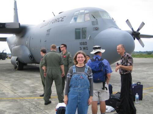 [Sisa DeJesus (centre), AusAID mental health consultant, in front of a United States Air force plane on the tarmac at Banda Aceh Airport, 7 January 2005] [picture] / AusAID, photographer Robin Davies