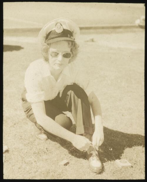 Joy Laurieton, cabin crew, tying her shoe lace, ca. 1952 [transparency] / Allan Hughes