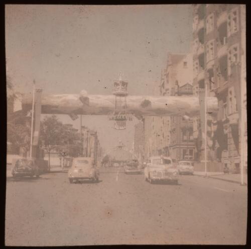 Royal tour decorations, mock tree trunk over road with a "Welcome" sign, Sydney, 1954 [transparency] / Allan Hughes