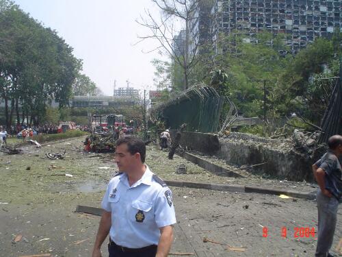 [View of the street running in front of the Australian Embassy with part of the fence destroyed by the impact of the explosion and neighbouring buildings in the background, Jakarta, Indonesia, 9 September 2004] [picture] / AFP staff member