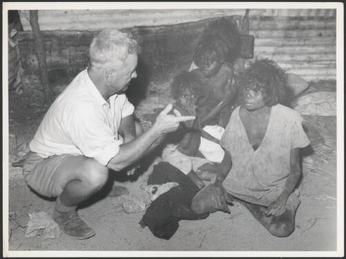 Bill Harney interviewing an Aboriginal girl at Goulburn Island concerning a spearing in the district, Goulburn Island, ca. 1940s [picture]