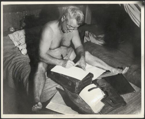 Bill Harney writing up his journal, Darwin Camp, Darwin, ca. 1940s [picture]