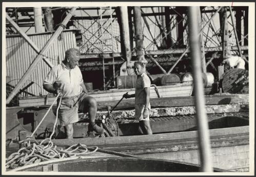 Bill Harney and unknown man working on a boat, Darwin jetty, Darwin, ca.1940s [picture]