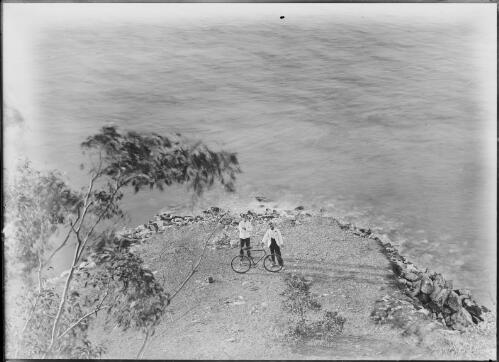 Two men with bicycle on coastline, Palmerston, former name of Darwin, ca. 1897 [picture] / Florenz Bleeser