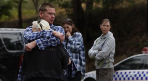 Brother and sister comfort each other after learning that his house had been destroyed in the bushfire, Maroondah Highway roadblock at Healesville, Victoria, 8 February 2009 [picture] / Justin McManus