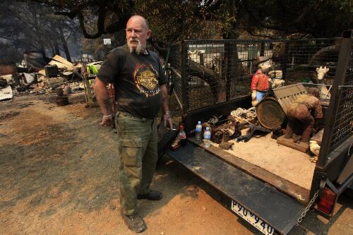 Robert Nills salvaging items from his burnt out home, Flowerdale, Victoria, 13 February 2009 [picture] / Justin McManus