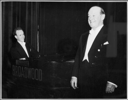 Portait of Peter Dawson, vocalist, with an unidentified pianist, ca. 1951 [picture]