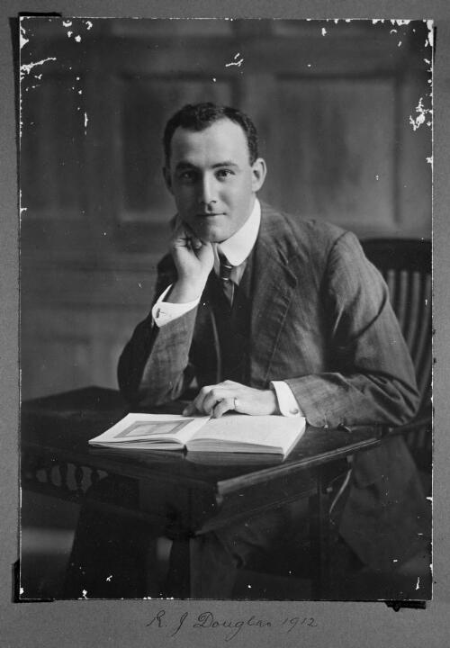 Portrait of Robert Johnstone Douglas at a desk, 1912 [picture]