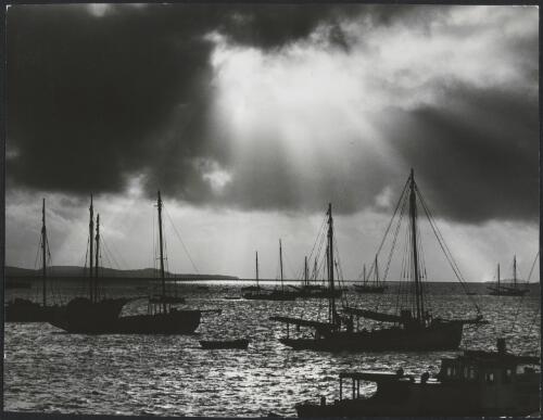 Daybreak at Thursday Island, showing part of the pearling fleet at anchor, Queensland, 1950 [picture] / Frank Hurley