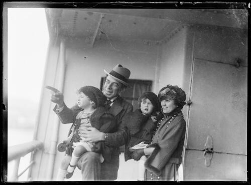 Frank and Antoinette Hurley, holding their twin daughters Adelie (left) and Toni (right), on board a ship, 1920? [picture]