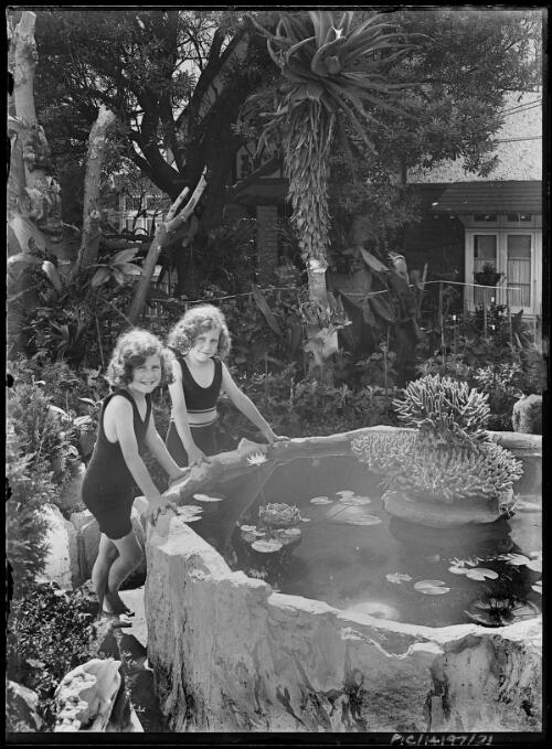 Adelie, left, and Toni Hurley at the fishpond at Stonehenge, Rose Bay, Sydney, ca. 1928 [picture] / Frank Hurley