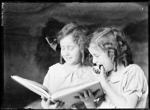 Portrait of Adelie, left, and Toni Hurley reading, ca. 1928, 1 [picture] / Frank Hurley