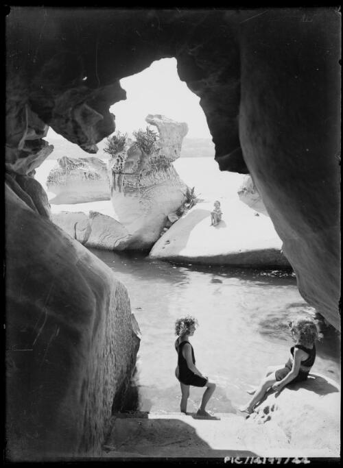 Yvonne, back, Adelie, left, and Toni Hurley at the natural swimming pool, Point Piper, Sydney, ca. 1927 [picture] / Frank Hurley