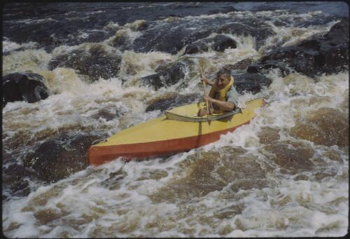 Olegas Truchanas in a kayak on the Huon River, southwest Tasmania, 1962? [transparency] / Peter Dombrovskis