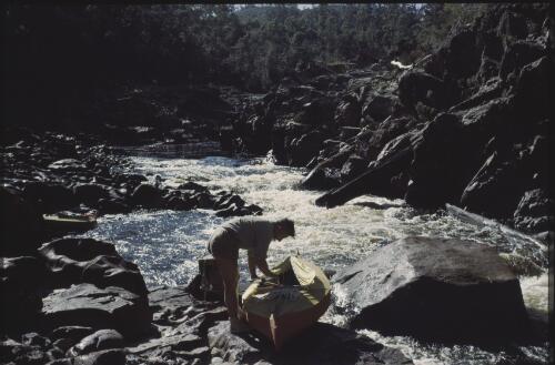 Olegas Truchanas with his kayak, upper gorge, Pieman River, Tasmania, 1962? [transparency] / Peter Dombrovskis