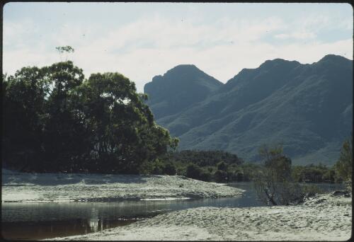 Small creek flowing into Lake Pedder, Frankland Range in background, southwest Tasmania, 1971 [transparency] / Peter Dombrovskis