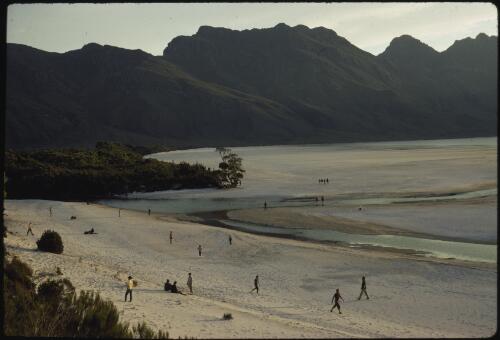 People on the beach, Lake Pedder with the Frankland Range in background, southwest Tasmania, 1971 [transparency] / Peter Dombrovskis