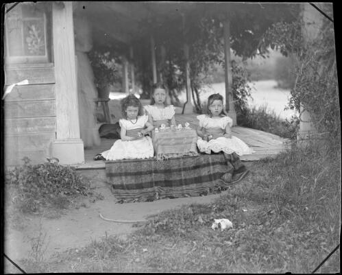 Nina, Charlotte, and May De Salis having a tea party at Lambrigg homestead, Australian Capital Territory, ca. 1895 [picture]