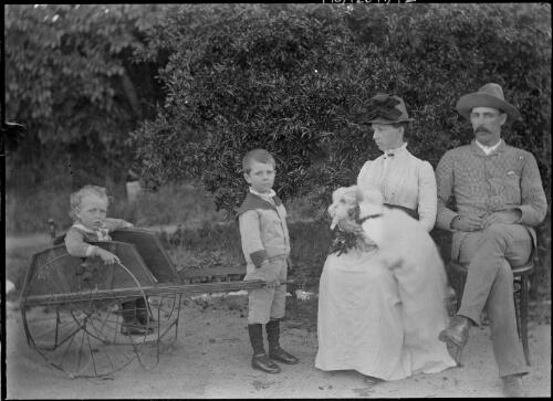 Maude MacDonald [?] nursing child, seated next to husband [?], with two children and a home-made cart, Australian Capital Territory, ca. 1900 [picture]
