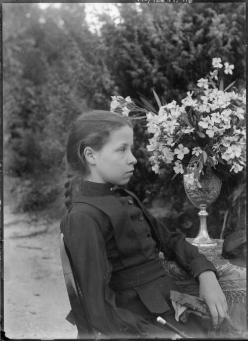 Portrait of Charlotte De Salis seated in garden with flower bouquet on table, Cuppacumbalong, Australian Capital Territory, ca. 1895 [picture]