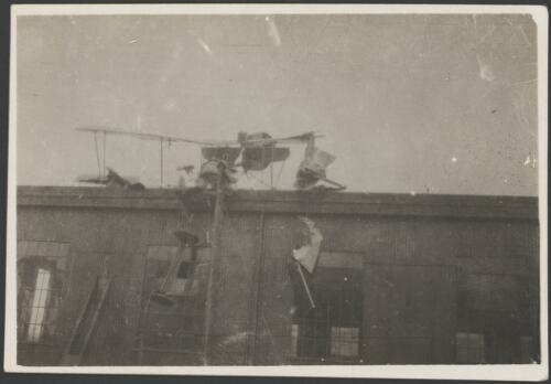 Wreckage of a military biplane crashed into the top of the building, England, 1917 [picture] / John Joshua