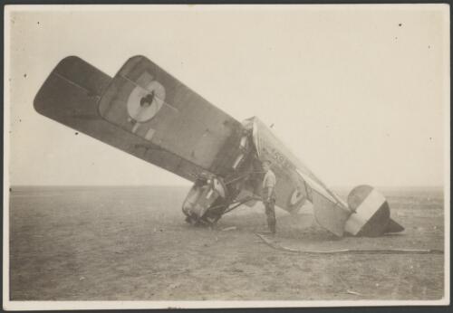 A soldier standing next to the crashed Avro 504J, A-5931, training biplane with fuselage bent at a right angle, South Carlton, England, 1917 [picture] / John Joshua
