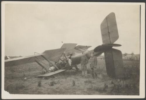 Three soldiers standing next to the wreckage of a crash landed Royal Aircraft Factory B.E.2 biplane, England, 1917 [picture] / John Joshua