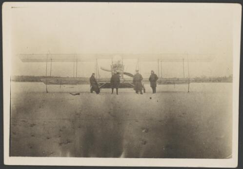 Four soldiers standing in front of a Maurice Farman MF.11 Shorthorn pusher biplane, France, 1917 [picture] / John Joshua