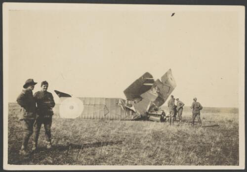 Members of 3 Squadron, Australian Flying Corps, examining the wreckage of a Royal Aircraft Factory R.E.8 biplane crashed on an open field, France, 1917 [picture] / John Joshua