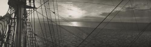 Panoramic view of the Discovery sailing through melted ice on calm waters, Antarctica, ca. 1929 [picture] / Frank Hurley