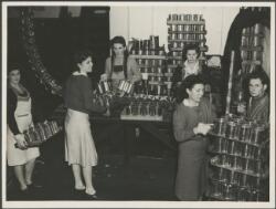 Women workers preparing cans on trays at Leeton Co-operative Cannery ...