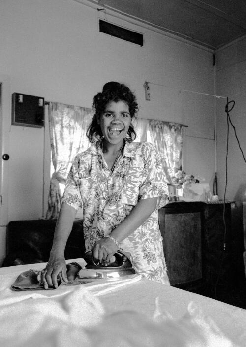 A young Aboriginal woman ironing on a table at Lake Tyres Mission, Victoria, ca. 1965 [picture] / Albert W. Brown