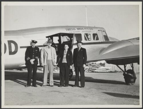 Captain Francis Finlay, Les Thiess, Cecil Thiess and engineer Roy McMenemy in front of the new Thiess Bros. company plane Avro Anson, [Queensland], 1947 [picture] / Thiess Bros. Pty Ltd