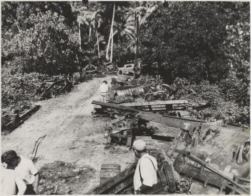 World War II equipment scattered beside dirt track, Noemfoor Island, Dutch New Guinea, 1953 [picture] / Thiess Bros. Pty Ltd