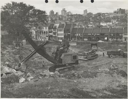 Thiess Bros. digging machine excavating during construction of the Domain carpark, Woolloomooloo, New South Wales, ca. 1956 [picture] / Thiess Bros. Pty Ltd