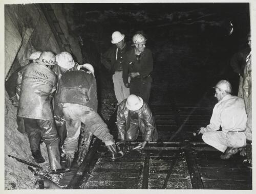 Workmen assembling sections of sliding floor in the Murray 1 pressure tunnel, Snowy Mountains, New South Wales, 1962? [picture] / Thiess Bros Pty Ltd